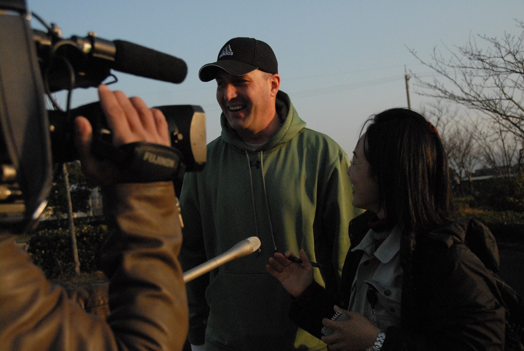 U.S. Air Force Master Sgt. Edward Waskosky, 35th Air Force Maintenance Squadron first shirt, is interviewed by Miki-San, local Komatsu, Japan reporter during a park clean up event at a local park, Dec. 5, 2010. Sergeant Waskosky is the first shirt for the U.S. Air Force Airmen deployed to Komatsu JASDF base in support of Keen Sword operations. (U.S. Air Force photo by 1st Lt. Cammie Quinn/ Released)