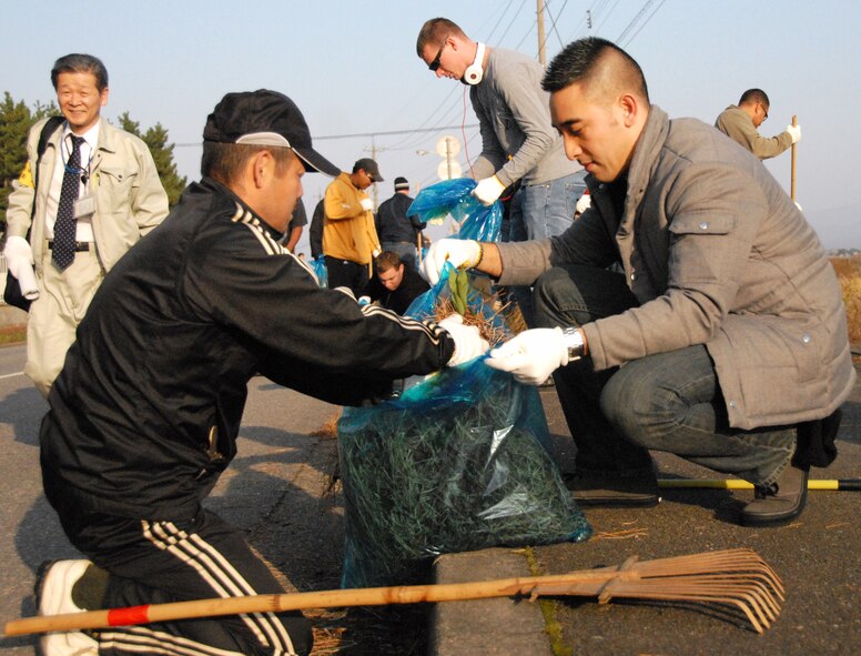 U.S. Air Force and Japan Air Self-Defense Force members clean leaves from the streets surrounding Komatsu JASDF base during a community volunteer event, Dec. 5, 2010. Members of both forces are participating in the bilateral exercise, Keen Sword.  During Keen Sword 2011, units from the United States Army, Navy, Air Force and Marine Corps conduct training with their Japan Self-Defense Force counterparts at military installations throughout mainland Japan, Okinawa and in the waters surrounding Japan. (U.S. Air Force photo by 1st Lt. Cammie Quinn)