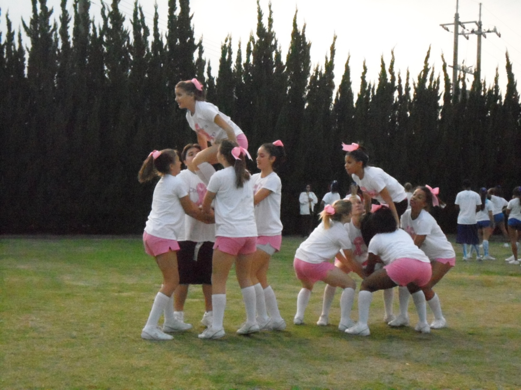 Members of Robert D. Edgren High School's cheerleading team practice a stunt in their Cheer for the Cure outfits during day four of the Far East Cheer Camp, Nov. 11, 2010, at Matthew C. Perry High School, Marine Corps Air Station Iwakuni, Japan. The Far East Cheer Camp is a five-day event where cheerleading teams from Pacific Department of Defense Dependents Schools train and compete for awards. In addition to the division II title, Edgren also received the safety, perfection before progression, organization, technique (S.P.O.T.) award for taking the necessary steps and precautions to prevent injuries during stunts. (Photo courtesy of Dr. Leah Sledge)
