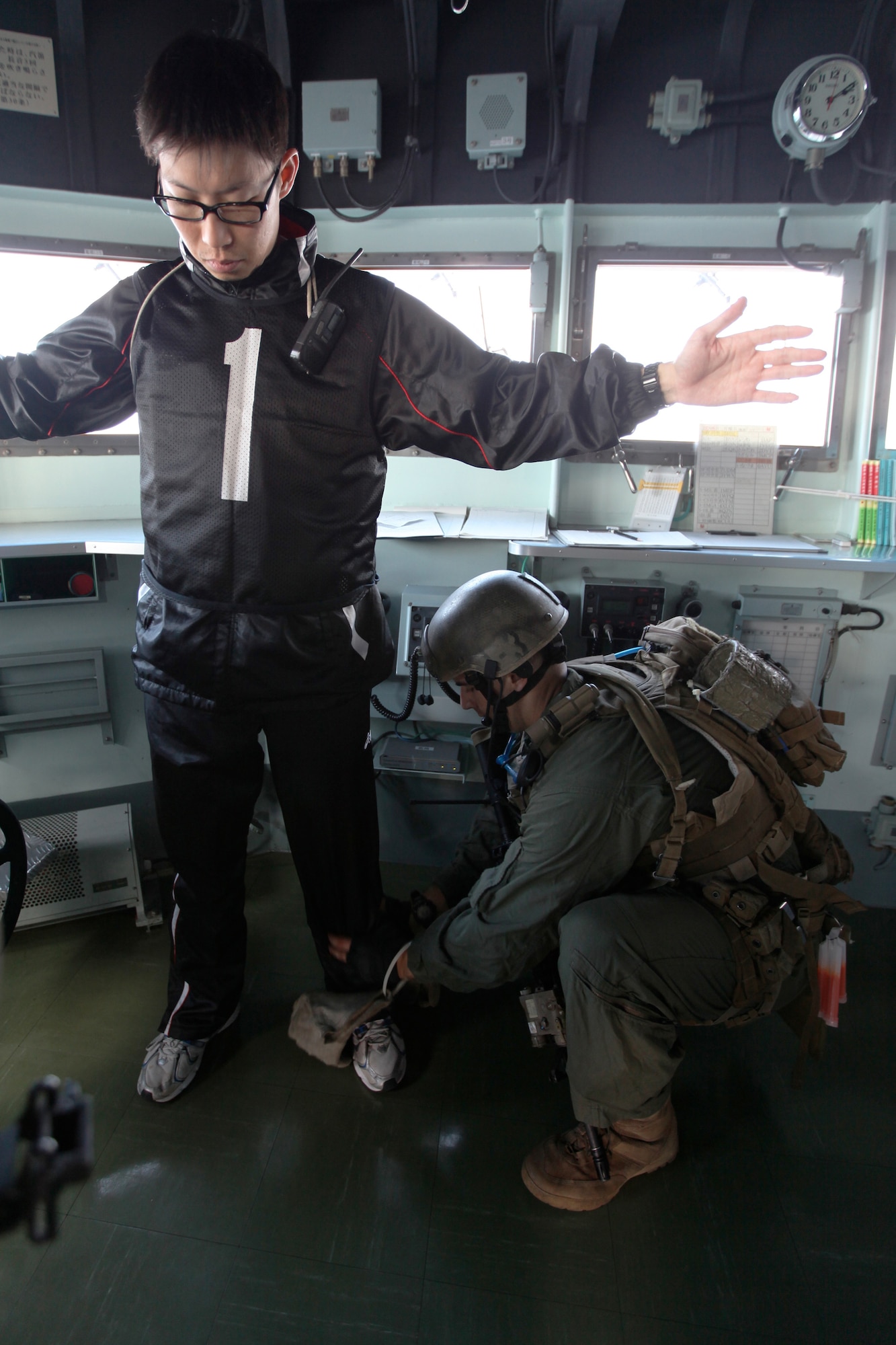 A U.S. Marine with Force Reconnaissance Platoon, 31st Marine Expeditionary Unit, searches the notional Captain of the Japan Maritime Self-Defense Force ship J.F. Kunisaki during a Visit, Board, Search, and Seizure exercise in support of Keen Sword 2010. (U.S. Marine Corps photo/Cpl. Kelsey J. Green)