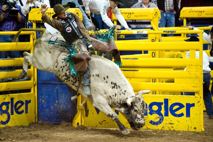 LAS VEGAS-- Bull rider Seth Glause from Rock Springs, Wyo., rides Texas Sancho during the fourth round of the National Finals Rodeo at the Thomas and Mack Center Dec. 5. (U.S. Air Force photo by Lawrence Crespo/Released) 