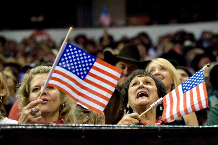 LAS VEGAS --  National Finals Rodeo fans wave American flags as a tribute to the men and women of the armed forces at the Thomas and Mack Center Dec. 5.  The NFR honored members of the armed forces for their service to our country. (U.S. Air Force photo by Lawrence Crespo/Released) 