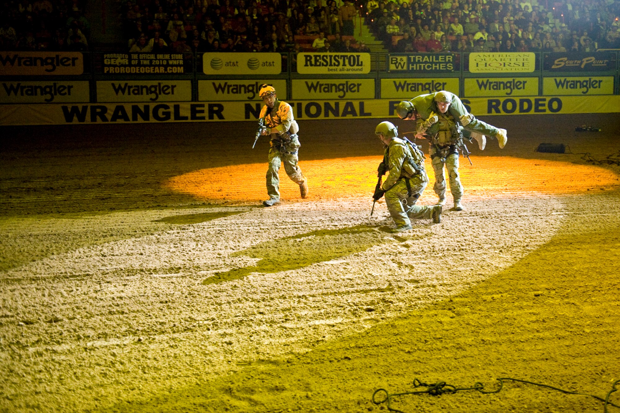 LAS VEGAS -- Members from the 58th Rescue Squadron, Nellis Air Force Base, Nev., rappel into the Thomas and Mack Center and simulate the rescue of a downed pilot during an opening ceremony demonstration prior the National Finals Rodeo Dec. 5.  The NFR paid tribute to the men and women of the armed forces for their service to our country. (U.S. Air Force photo by Lawrence Crespo/Released) 