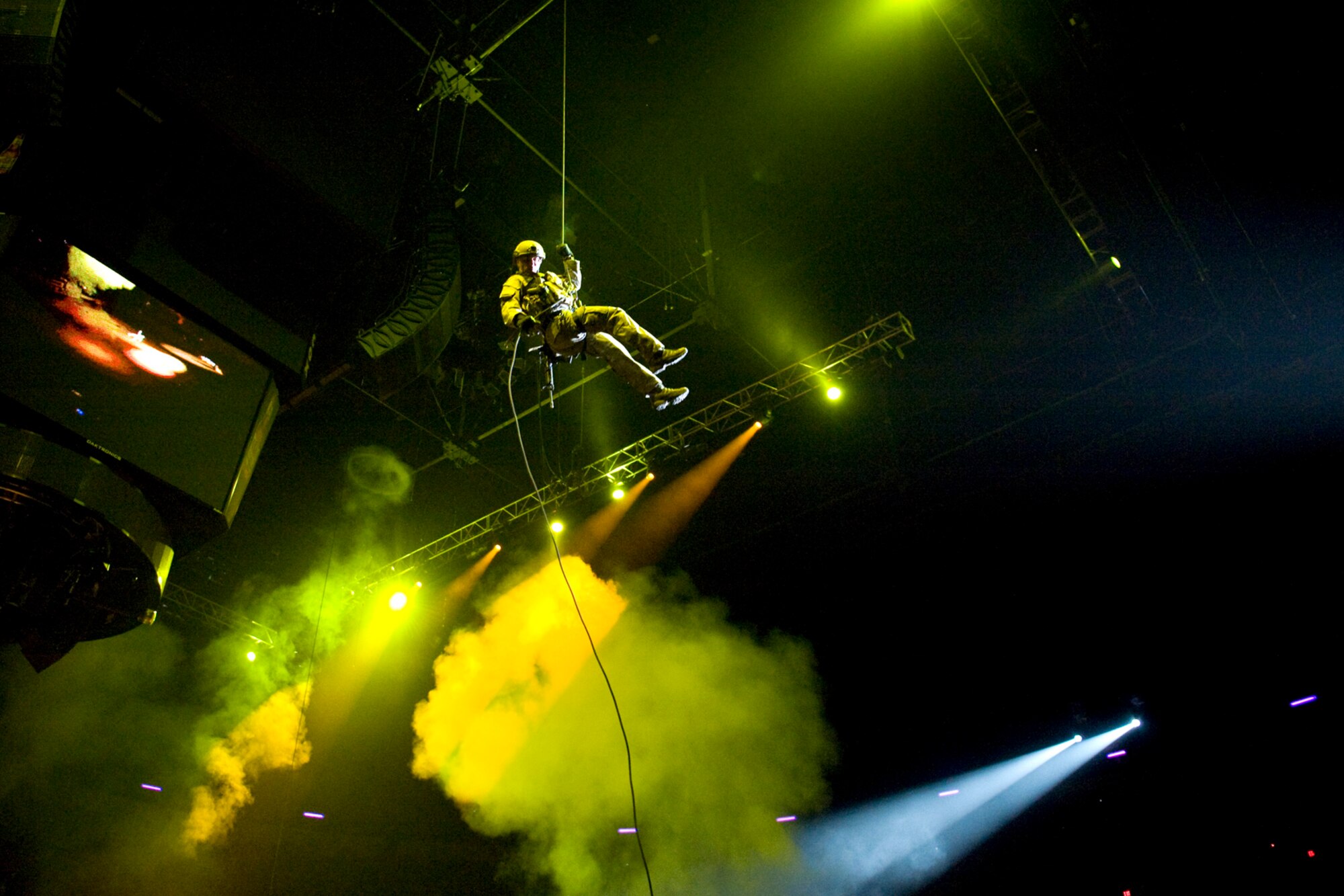 LAS VEGAS -- Members from the 58th Rescue Squadron, Nellis Air Force Base, Nev., rappel into the Thomas and Mack Center during an opening ceremony demonstration prior the National Finals Rodeo Dec.5. The NFR paid tribute to the men and women of the armed forces for their service to our country. (U.S. Air Force photo by Lawrence Crespo/Released) 