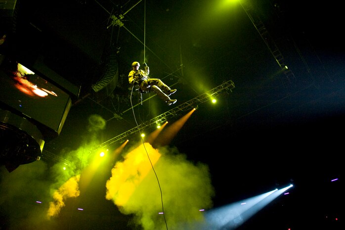 LAS VEGAS -- Members from the 58th Rescue Squadron, Nellis Air Force Base, Nev., rappel into the Thomas and Mack Center during an opening ceremony demonstration prior the National Finals Rodeo Dec.5. The NFR paid tribute to the men and women of the armed forces for their service to our country. (U.S. Air Force photo by Lawrence Crespo/Released) 