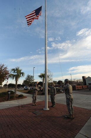 From left to right, Staff Sgts. Neil White, Jennifer Pentecost and Michael Whitcomb lower the flag during a retreat ceremony at Joint Base Charleston-Air Base, S.C., Dec. 3, 2010. The ceremony is coordinated with the playing of the national anthem and the lowering of the flag so that the two are completed at the same time. Sergeants White, Pentecost and Whitcomb are members of the 628th Security Forces Squadron. (U.S. Air Force photo/James M. Bowman)