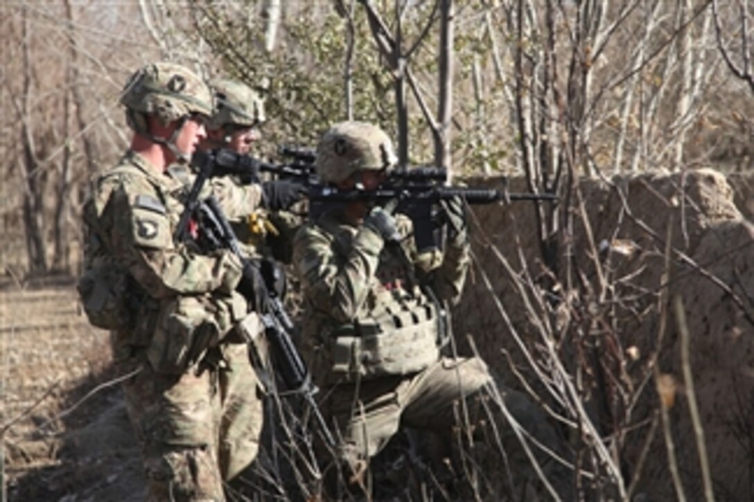 U.S. Army Staff Sgt. Peter Moeller (left), Sgt. Kris Rude and 1st Lt. Ben Davis (right), all combat engineers with 832nd Engineers Company, attached to 1st Squadron, 113th Cavalry Regiment, provide security for fellow soldiers during a patrol in Dolatshi village, Parwan province, Afghanistan, on Dec. 2, 2010.  