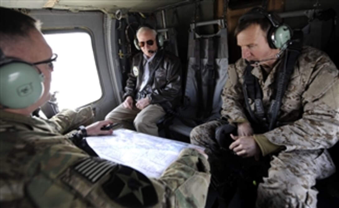 Secretary of Defense Robert M. Gates receives an operational brief from Army Brig. Gen. Jeffrey Bannister, 11 Mountain Division and his Senior Military Assistant Rear Adm. Joseph Kernan while en route to Forward Operating Base Howz-e-Madad, Afghanistan, on Dec. 8, 2010.  