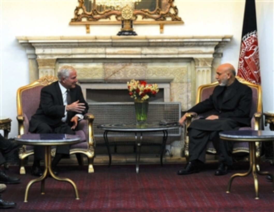 Secretary of Defense Robert M. Gates talks with Afghan President Hamid Karzai in the Presidential Palace in Kabul, Afghanistan, on Dec. 8, 2010.  