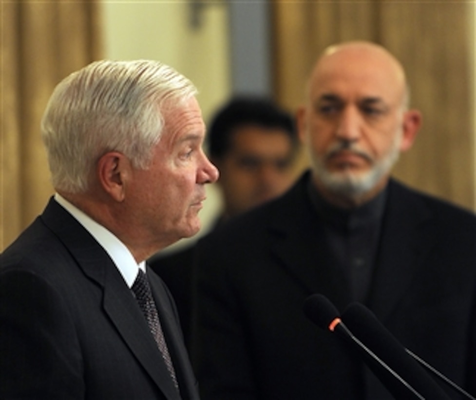 Secretary of Defense Robert M. Gates answers a question from the press while Afghan President Hamid Karzai looks on in the Presidential Palace in Kabul, Afghanistan, on Dec. 8, 2010.  