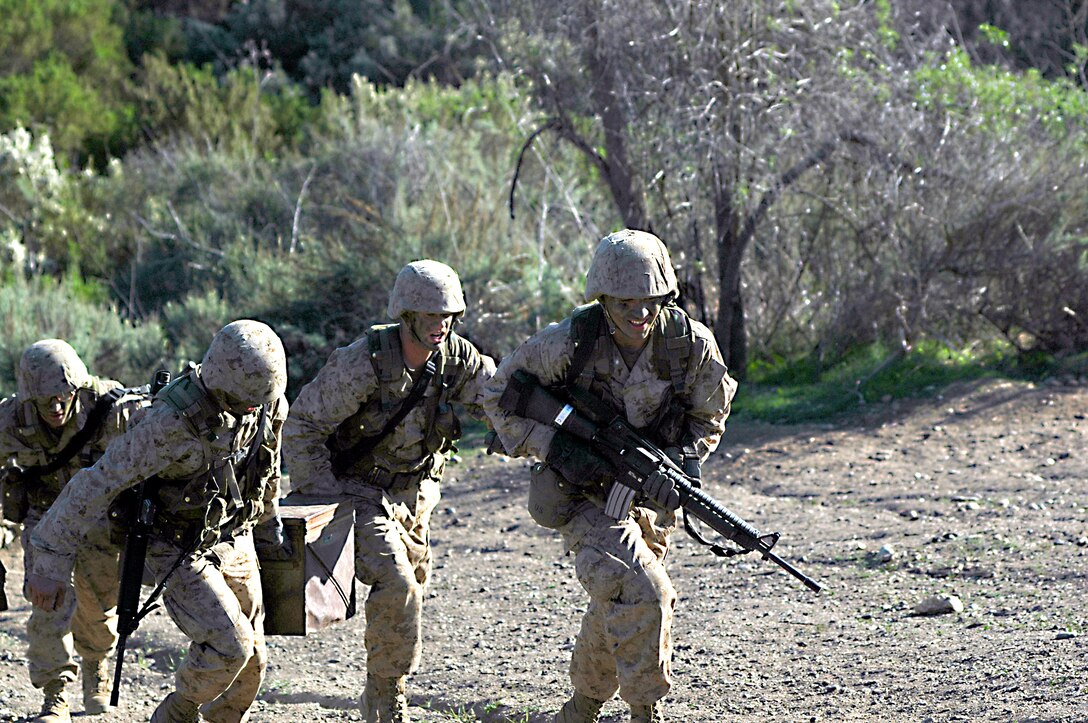 Recruits used teamwork to get heavy ammunition containers to a designated point during a mission known as Basilone’s Challenge, named after Gunnery Sgt. John Basilone, recipient of the Medal of Honor and Silver Star for his actions at the Battle of Guadalcanal. ::r::::n::