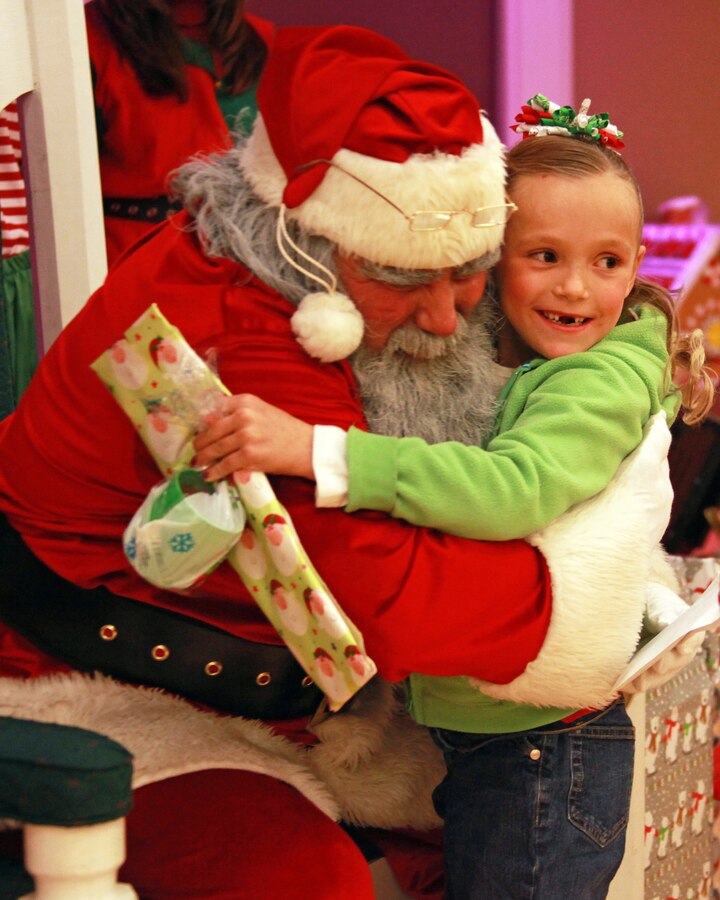 Santa Clause gives a hug to a girl during the annual 24th Marine Expeditionary Unit Christmas Party Dec. 8, at the Marston Pavilion on Camp Lejeune, N.C. Marines with the 24th MEU and their families gathered together to celebrate the holiday season.