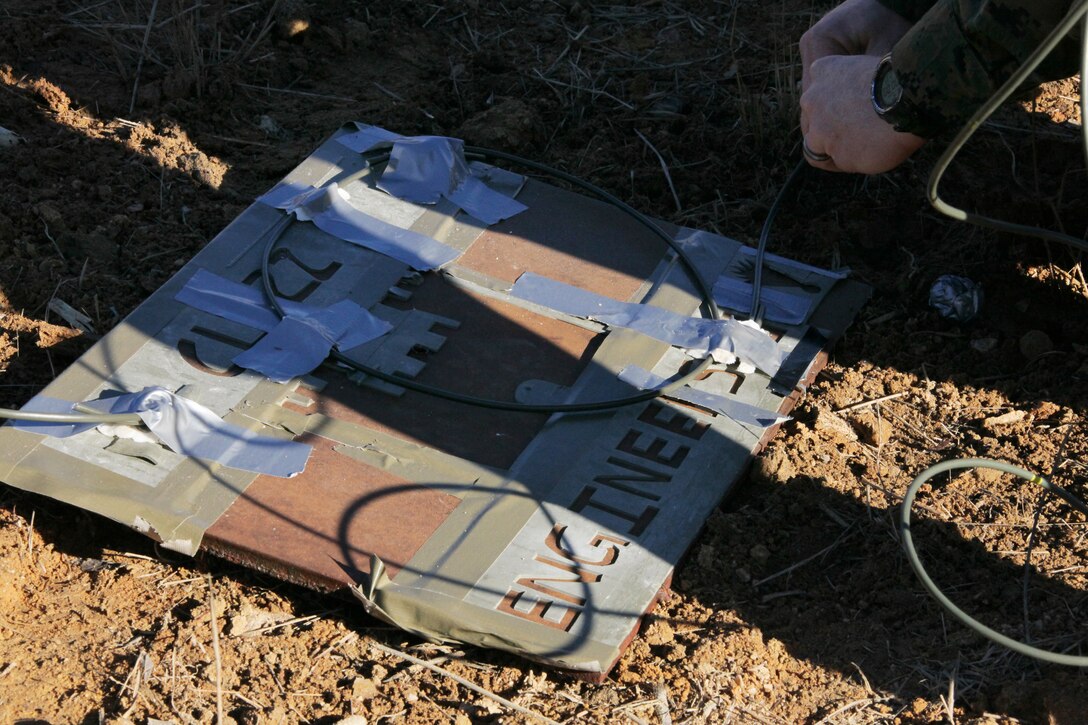 Combat engineers with Combat Logistics Battalion 22, 22nd Marine Expeditionary Unit primes a steel-nickel plate with data sheet explosive taped in designs aboard Fort Pickett, Va, Dec. 8, 2010.  The 22nd MEU and support elements are conducting a series of training events ranging from maintenance on vehicles to full-scale mechanized assaults designed to prepare for the upcoming deployment in 2011.  The Marines and sailors of the 22nd MEU recently began an aggressive series of progressively, more complex pre-deployment exercises designed to train and test the MEU's ability to operate as a cohesive and effective fighting force.  The 22nd MEU is a multi-mission capable force of 2,200 Marines and sailors and comprised of Aviation Combat Element, Marine Tilt Rotor Squadron 263 (Reinforced); Logistics Combat Element, Combat Logistics Battalion 22; Ground Combat Element, Battalion Landing Team, 2nd Battalion, 2nd Marine Regiment; and its command element.