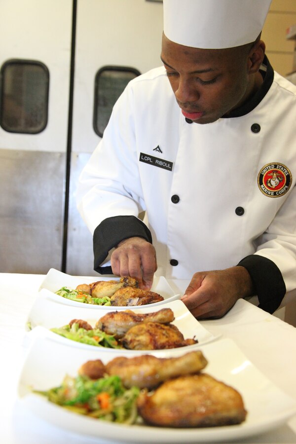 Lance Cpl. Rashaad S. Riboul puts the final touches on the dish he’s prepared for Cherry Point’s first chef of the quarter competition of the fiscal year at the Cherry Point Mess Hall Dec. 9. Riboul is a food service specialist with Marine Wing Support Squadron 274.