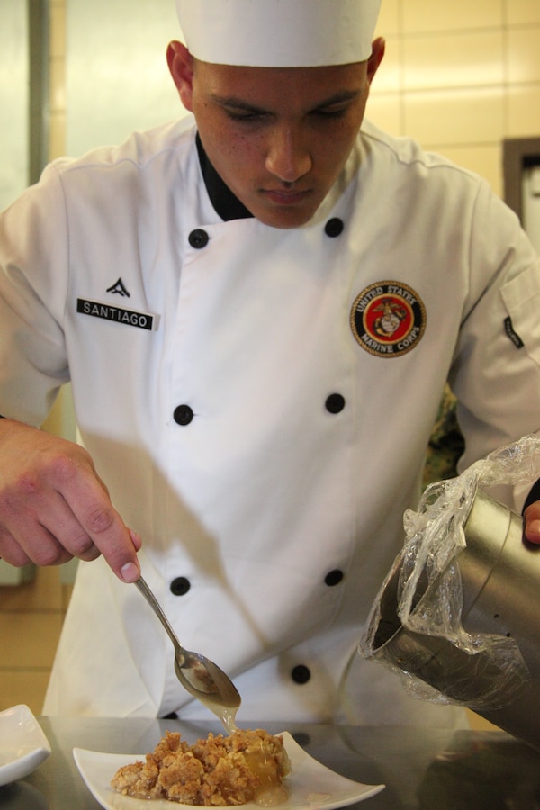 ::r::::n::Lance Cpl. Jose A. Santiago glazes apple crisp for the chef of the quarter competition at the Cherry Point Mess all Dec. 9. Santiago said he felt pretty relaxed throughout the competition because when he was growing up, cooking was one of the first things he was taught.::r::::n::