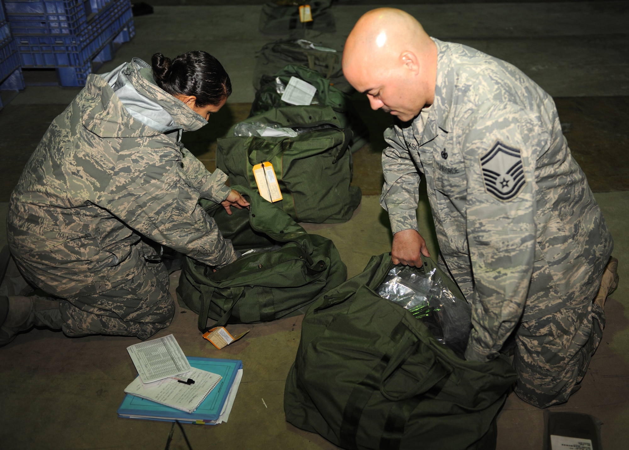 KUNSAN AIR BASE, Republic of Korea -- Senior Master Sgt. Todd Jackson and Tech Sgt. Angela Tuckett, Logistics Compliance Assessment Program supply evaluators checks mobility bags here Dec. 8, 2010. The LCAP is done to ensure compliance with regulations and directives are being followed and enforced with daily requirements in the maintenance and logistics career fields. (U.S. Air Force photo/Senior Airman Ciara Wymbs) 