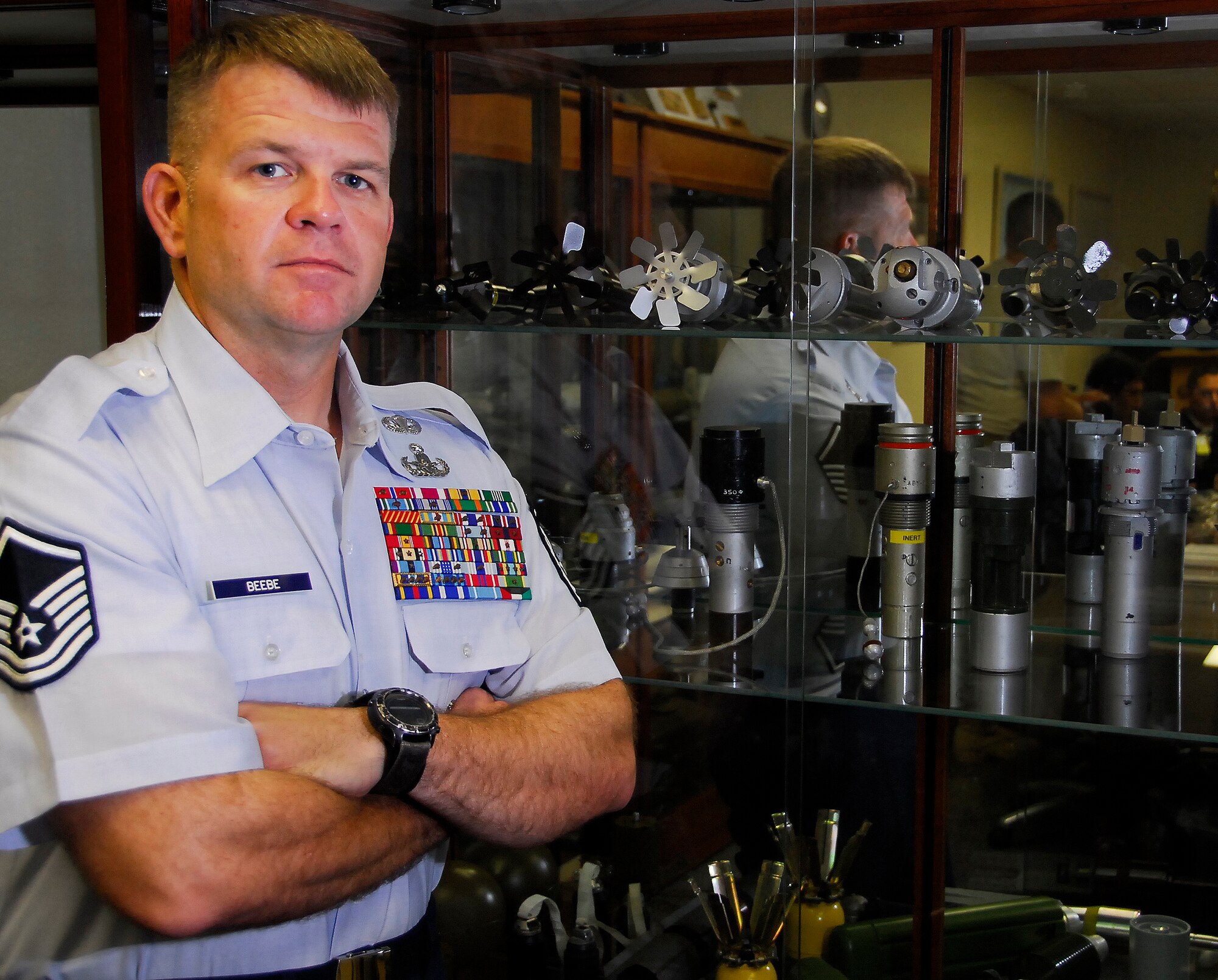 Master Sgt. John Beebe, an explosives ordnance disposal technician, leans against a display case in the EOD conference room, Dec. 7. Sergeant Beebe, a 20-year Marine Corps and Air Force veteran and currently Kadena's 18th Civil Engineer Squadron EOD superintendent, received his third Bronze Star Medal, Nov. 5, for services during Operation Iraqi Freedom earlier this year. (U.S. Air Force photo/ Airman 1st Class Maeson L. Elleman)