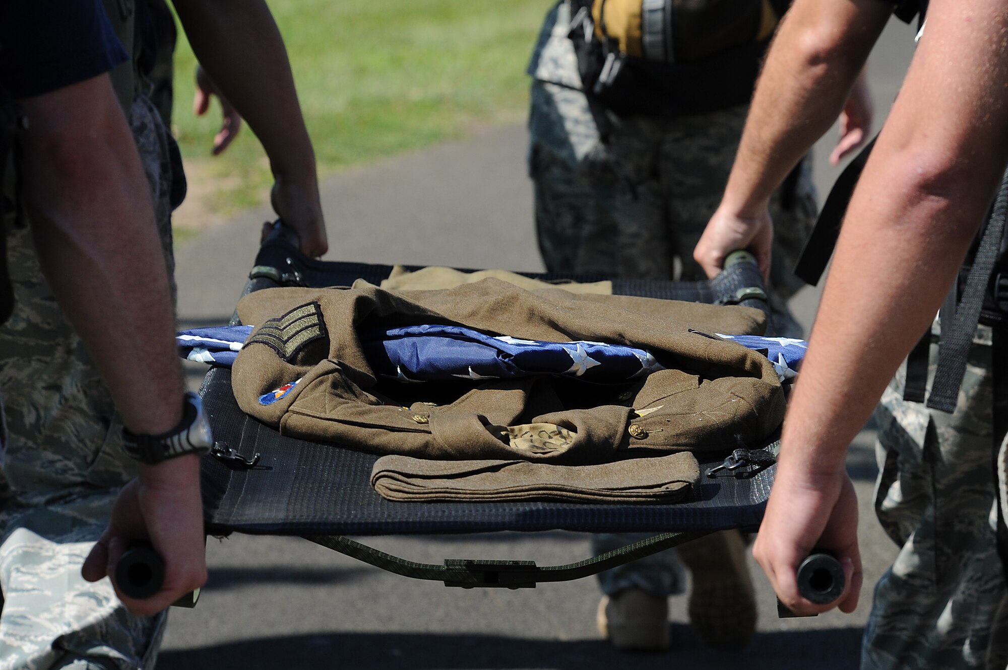 Member s of the 15th Medical Group carries a stretcher with a uniform of a World War II Army Air Corps medical corpsman during a more than 14-mile march Dec. 7.   Eight Medical group Airmen marched more than 69 accumulated miles in their combat boots, carrying a stretcher and weighted backpacks to honor the pain and sacrifice Americans went through 69 years ago in Hawaii. (U.S. Air Force photo/Staff Sgt. Mike Meares)