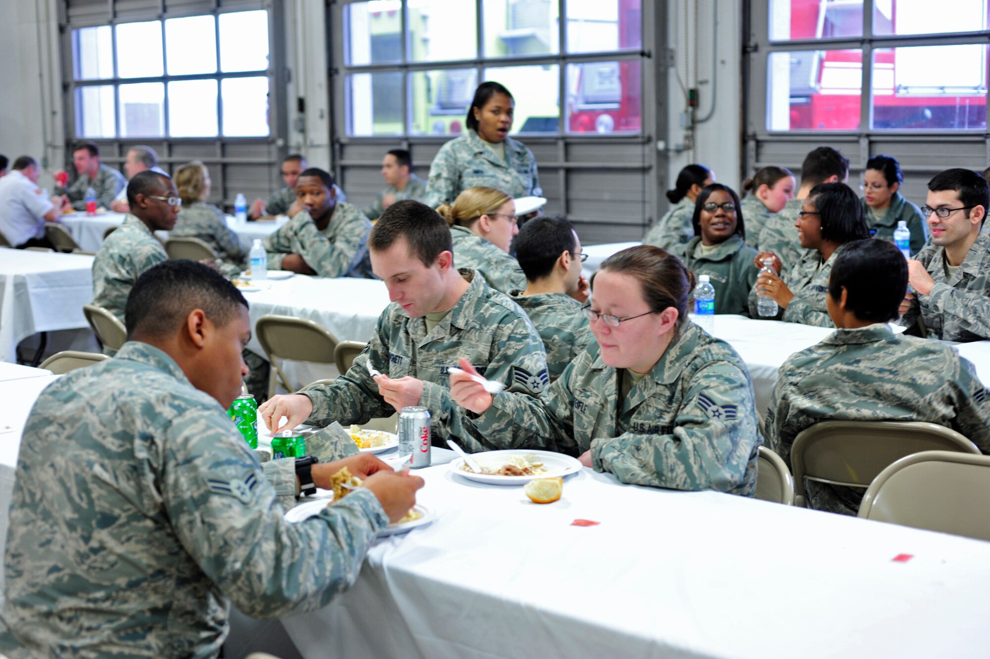 Airmen enjoy mashed potatoes, ham, green beans and other holiday food at the unaccompanied Airmen feast Dec. 9 at McChord Field, Joint Base Lewis-McChord, Wash. The meal is an opportunity to give back to the Airmen and provide a home cooked meal. (U.S. Air Force photo/Adamarie Lewis-Page)