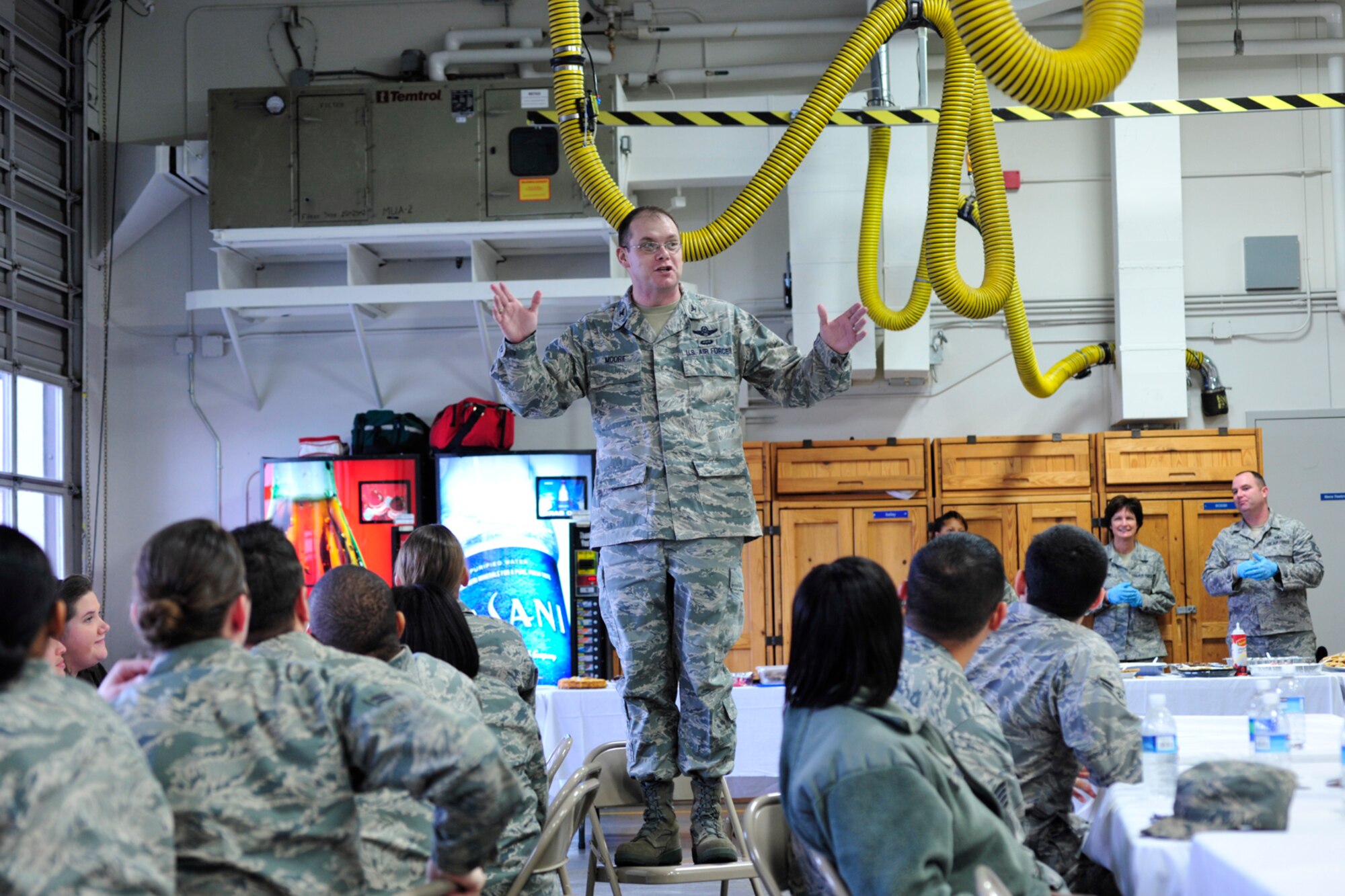 Col. Richard Moore, 62nd Airlift Wing vice commander, speaks to a group of Airmen during the unaccompanied Airmen feast Dec. 9 at McChord Field, Joint Base Lewis-McChord, Wash. More than 100 Airmen, living away from their families, enjoyed a home cooked meal.  (U.S. Air Force photo/Adamarie Lewis-Page)