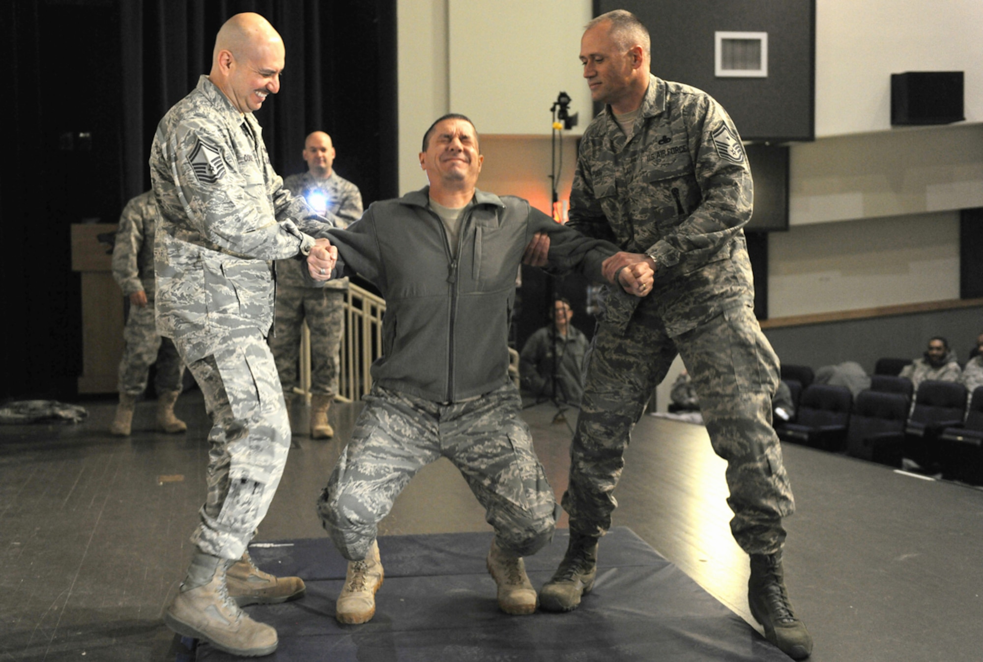 Chief Master Sgt. Richard Bruno reacts to being shot in the back with a Taser during a demonstration Dec. 7, 2010, at Kunsan Air Base, South Korea. The Taser is the newest non-lethal-force asset option for security forces members to use to contain potentially harmful situations. Chief Bruno is a member of the 8th Security Forces Squadron. (U.S. Air Force photo/Staff Sgt. Jonathan Pomeroy)