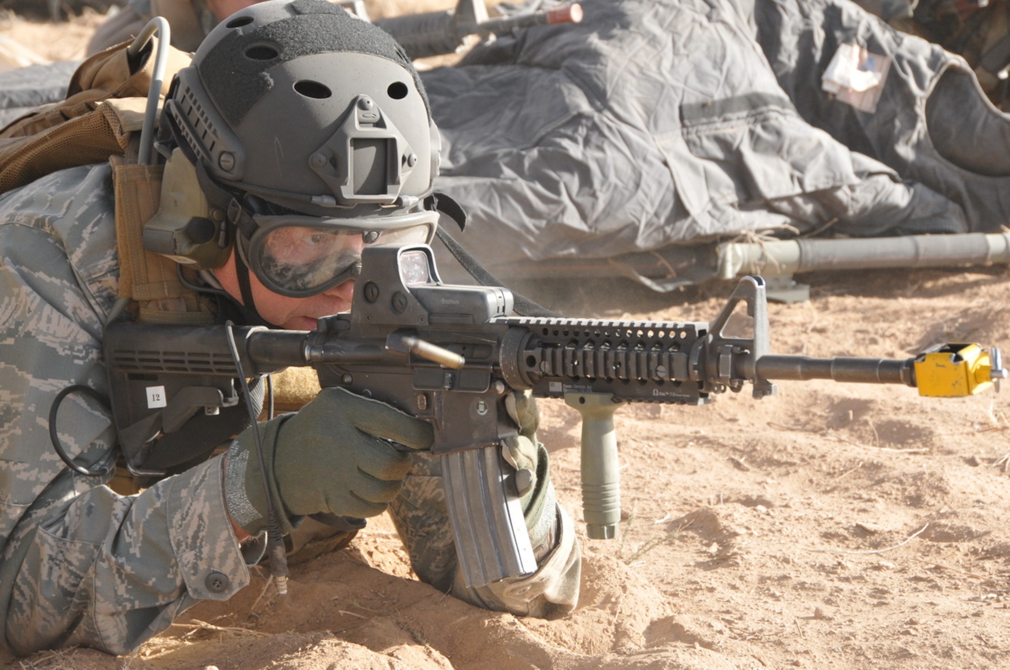 A round flies from the chamber of Gen. William M. Fraser's M-4 assault rifle
during a mass casualty exercise at Camp Plite, N.M., Dec. 8. The commander
of Air Combat Command visited with combat rescue officers and pararescuemen
at the PJ Schoolhouse as well as participated in the exercise during a trip
to Kirtland Air Force Base, N.M. (courtesy photo)

