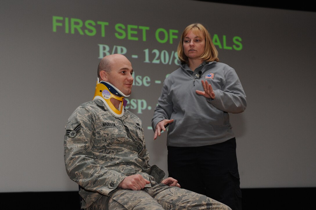LANGLEY AIR FORCE BASE, Va. – Senior Airman Jason Haddock, (left), 71st Fighter Wing crew chief, plays the role of an accident victim while Kirsten Svela, firefighter/paramedic, explains the process a patient goes through while suffering from major injuries from a car accident Dec. 9. Ms. Svela is part of the Florida S.A.F.E. (Stay Alive From Education) Inc., an international nonprofit organization dedicated to making teens and military personnel aware of the consequences of driving under the influence, illegal drug use, non-compliance of seat belts, and the trauma associated with these dangers.  (U.S. Air Force photo/Senior Airman Brian Ybarbo)(RELEASED)