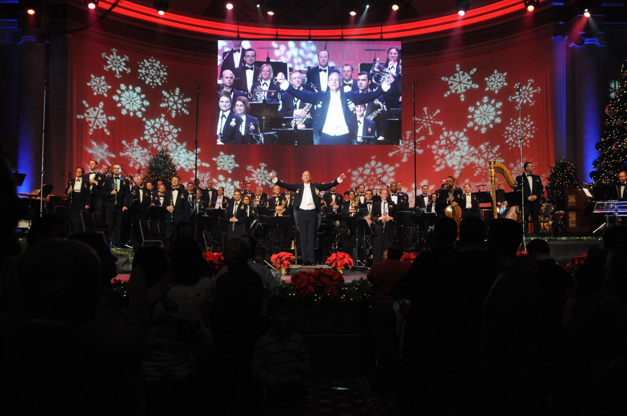 Lt. Col. A. Phillip Waite, commander and conductor of The United States Air Force Band, acknowledges the audience's applause during one of the Band's holiday concerts at DAR Constitution Hall. For this year's performances, the Concert Band, Singing Sergeants, and Ceremonial Brass joined forces to offer over 10,000 attendees "The Best Gift of All." (U.S. Air Force photo by Senior Airman Christopher Ruano) 