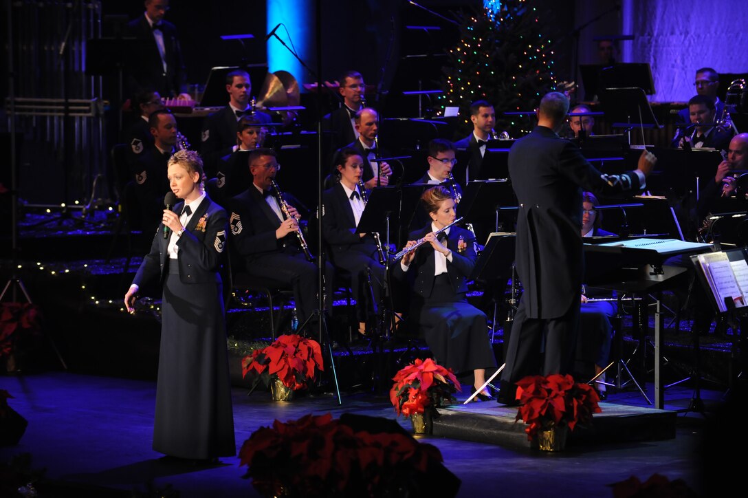 Senior Master Sgt. Angela Burns sings "Grown-Up Christmas List" as part of The United States Air Force Band's holiday concerts at DAR Constitution Hall. For this year's holiday performances, the Concert Band, Singing Sergeants, and Ceremonial Brass joined forces to offer over 10,000 attendees "The Best Gift of All." (U.S. Air Force photo by Senior Airman Christopher Ruano) 