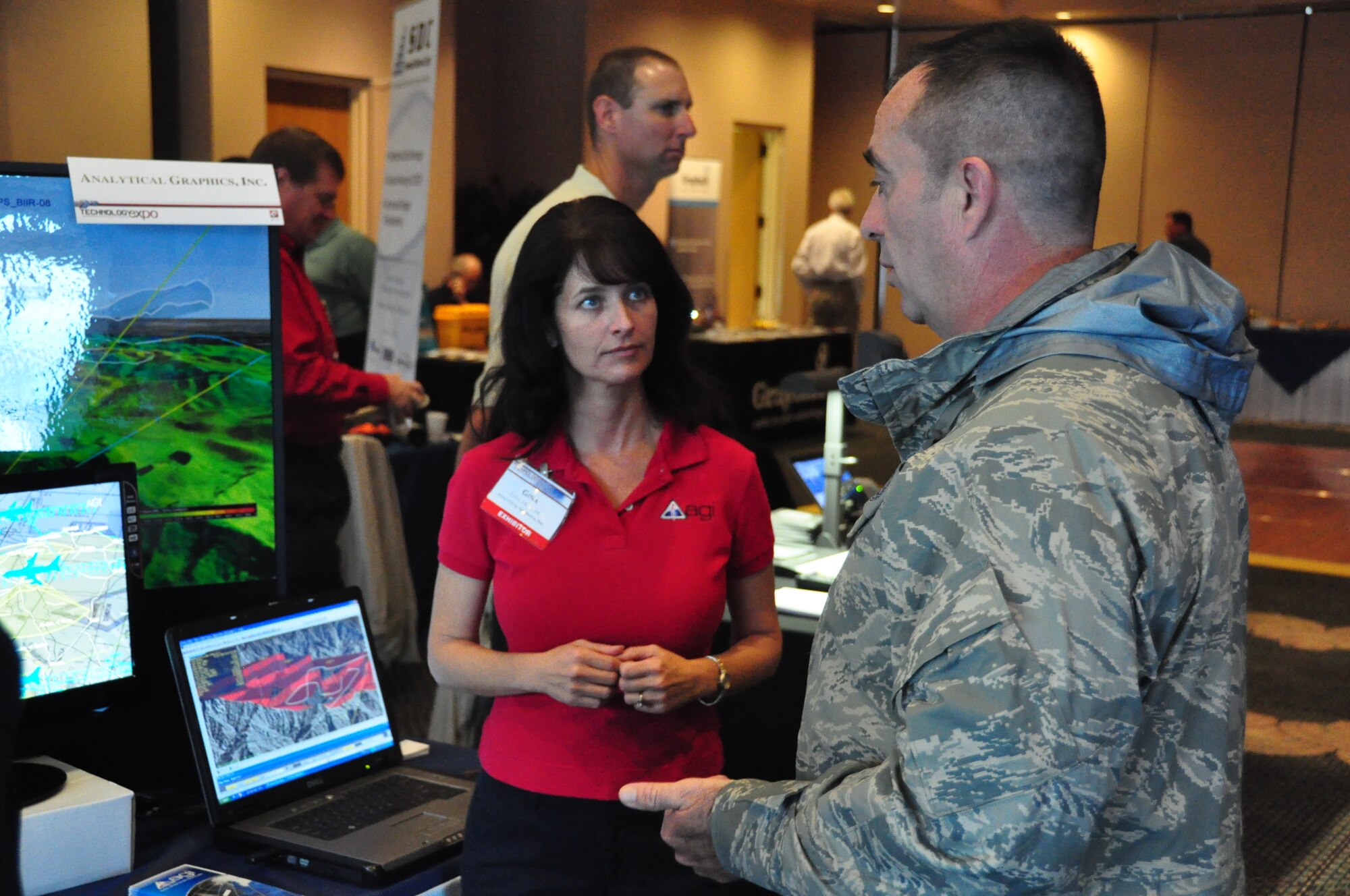 Senior Master Sgt. Timothy Griffin, 325th Communications Squadron plans and resources flight chief, listens to Gina Densler, Analytical Graphics Incorporated represented, talk about software analysis for land sea and space during the Technology Expo Dec. 8.  (U.S. Air Force photo/ Airman 1st Class Christopher Reel) 