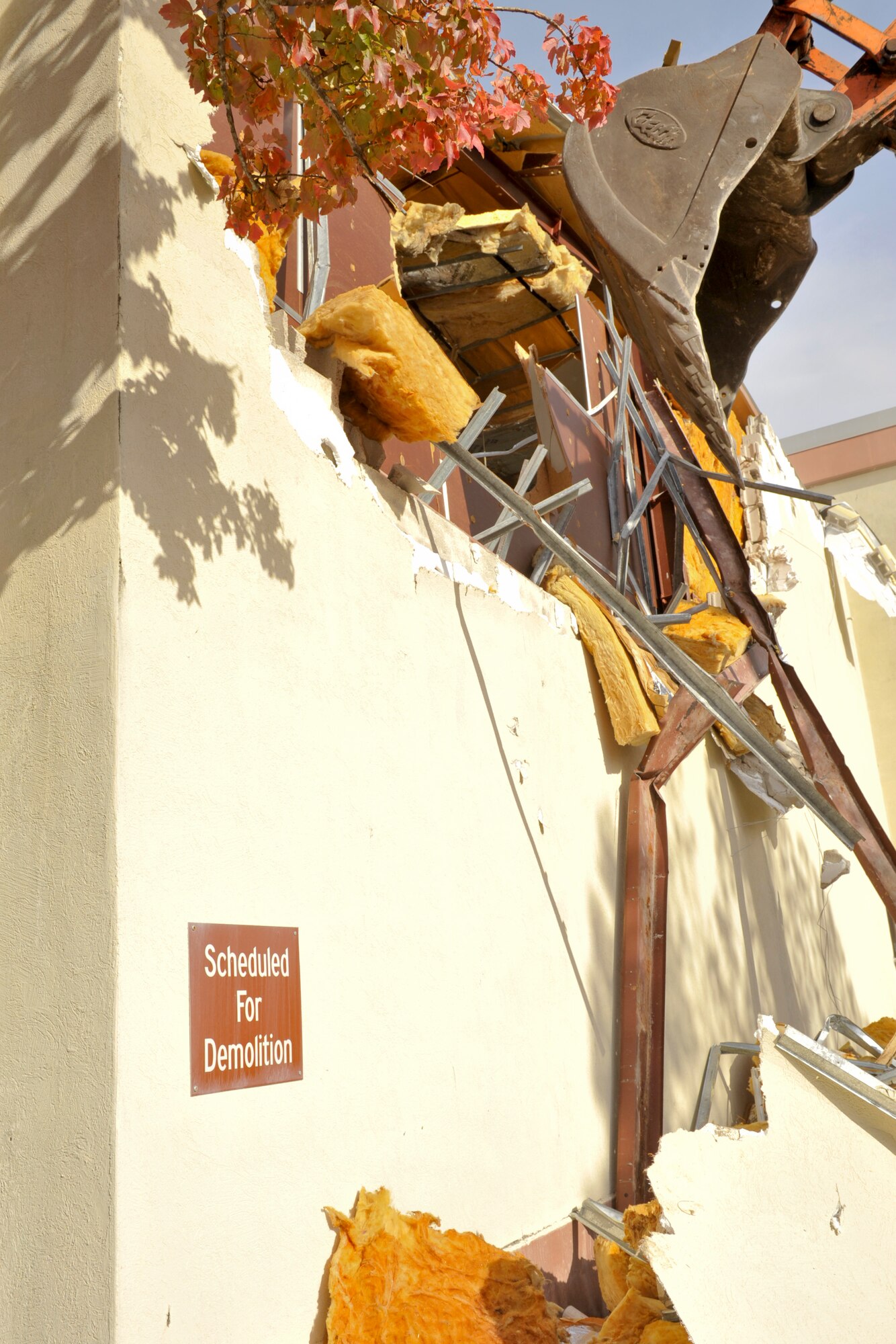 The excavator operated by Col. Michael Fleck, 325th Mission Support Group commander, tears out the first chunk of wall to begin the demolition of Tyndall's old fitness center building. (U.S. Air Force photo by Jonathan Gibson)
