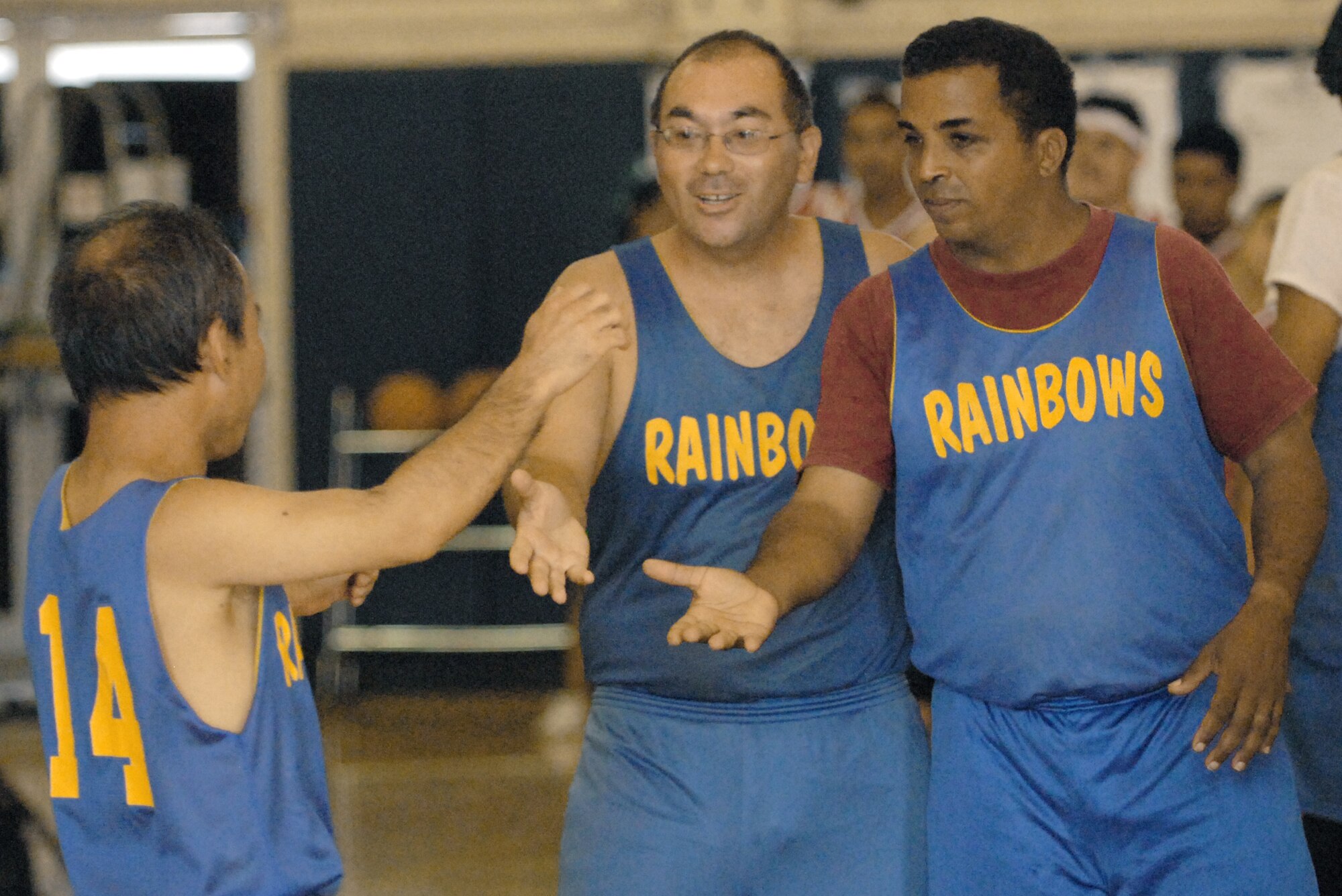 Special Olympics Rainbows basketball team members share a moment of camaraderie during a game Dec. 4, 2010, at Joint Base Pearl Harbor-Hickam, Hawaii. (U.S. Air Force photo/Staff Sgt. Carolyn Viss) 