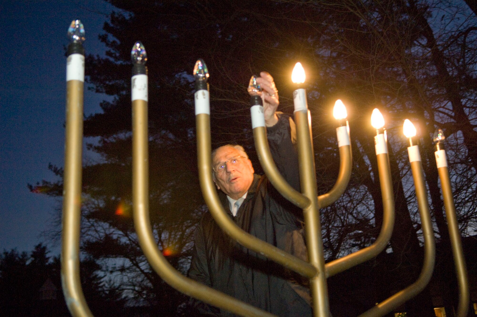HANSCOM AIR FORCE BASE, Mass. -- Rabbi Abraham Morhaim lights the Menorah as members of the Hanscom Jewish community gather on Dec. 7 at the Base Chapel to observe Chanukah. Chanukah lasts for eight days and nights. (U.S. Air Force photo by Mark Wyatt)