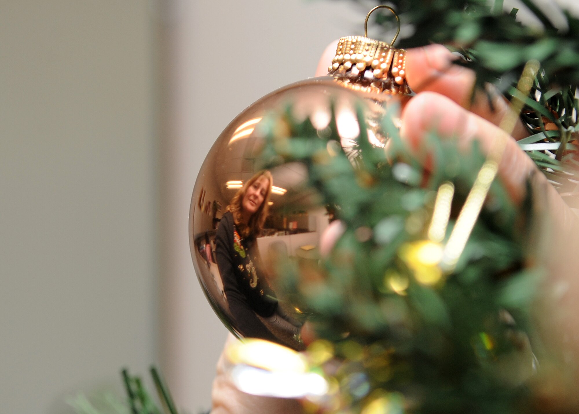 Buckley Air Force Base, Colo.-  Mrs. Laura Jacobson from the 460th SCS/SCOKR sqaudron, shows her holiday cheer by decorating her office Christmas tree. ( U.S. Air Force Photo by Airman First Class Marcy Glass )