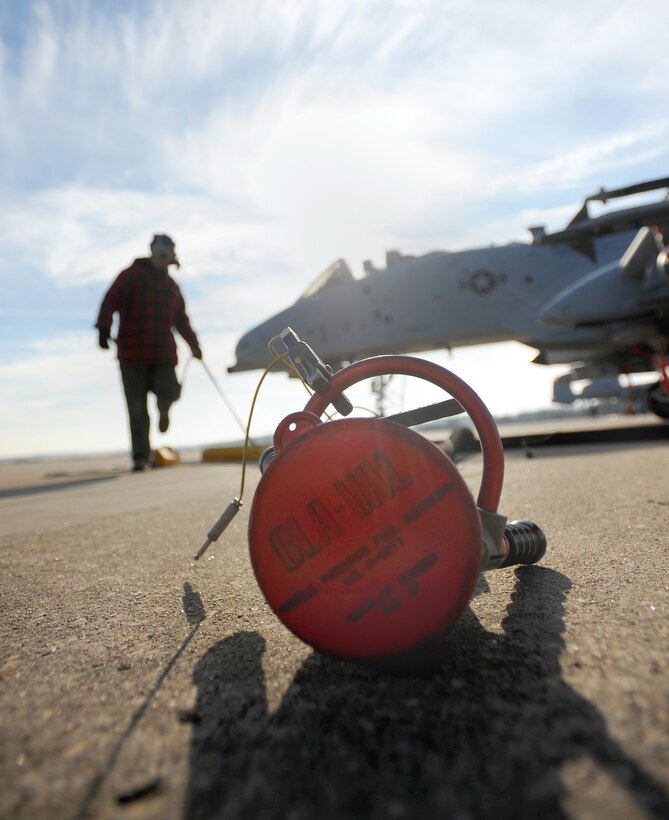 A jet fuel hose for refueling is discarded after a hot pit refuel for a 442nd Fighter Wing A-10 Thunderbolt Dec. 8, 2010, at Whiteman Air Force Base, Mo. Hot pit refueling is a procedure usually performed in a combat situation to rapidly refuel aircraft while their engines are running to thrust pilots back into the fight. (U.S. Air Force photo/Senior Airman Kenny Holston)