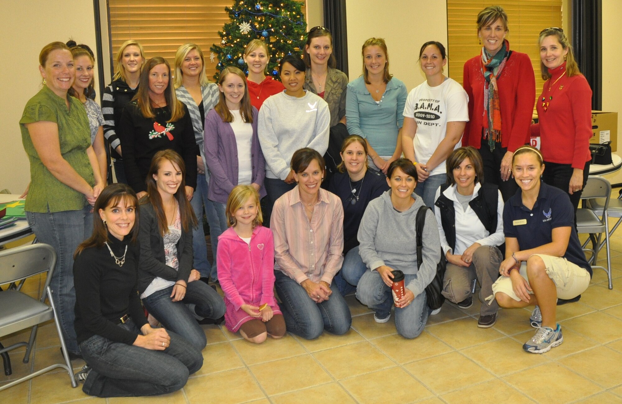 LAUGHLIN AIR FORCE BASE, Texas - - Volunteers for the Officer’s Spouses Club Cookie Caper pose for a group picture after preparing 642 packages of holiday cookies for single active duty members of Laughlin (U.S. Air Force photo by 2nd Lt. Angela Martin) 