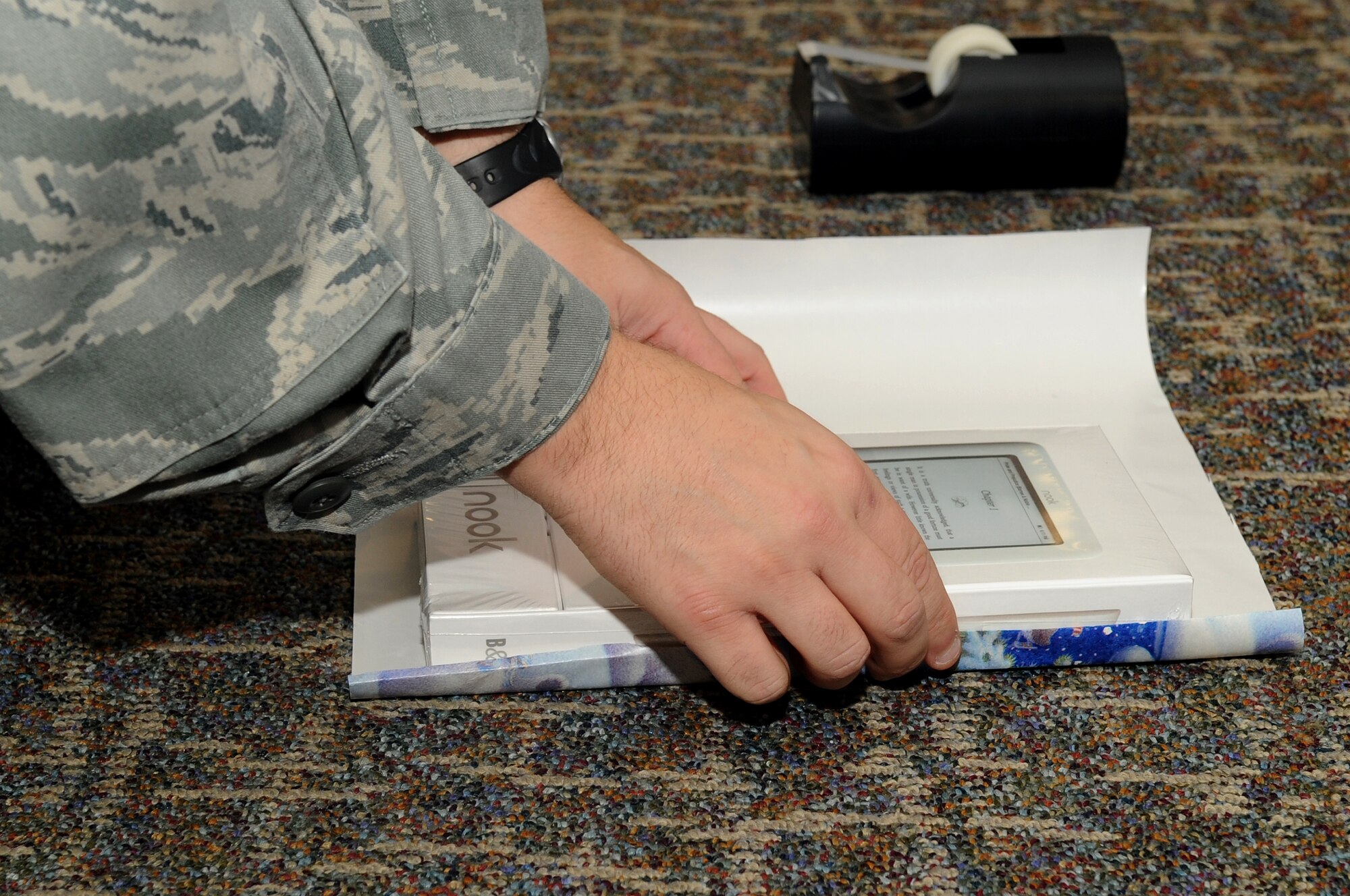 460th Space Communications Squadron, Tech Sgt. Robert Colwell wraps a gift for the holidays. Colwell plans to give the present to his wife for Christmas. (U.S. Air Force Photo By Airman Manisha Vasquez) 
