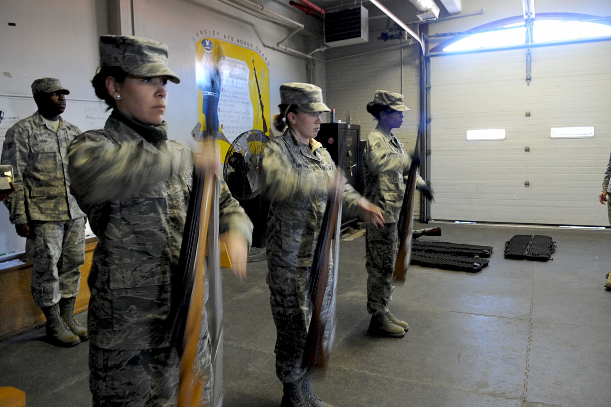 LANGLEY AIR FORCE BASE, Va -- Airmen of the base honor guard demonstrate rifle drill in the honor guard building during practice Dec. 7. Airmen of the base honor guard volunteer for three months outside of their career fields to perform ceremonial duties for veterans, retirees and active-duty members. (U.S. Air Force photo/Staff Sgt. Ashley Hawkins)(RELEASED)