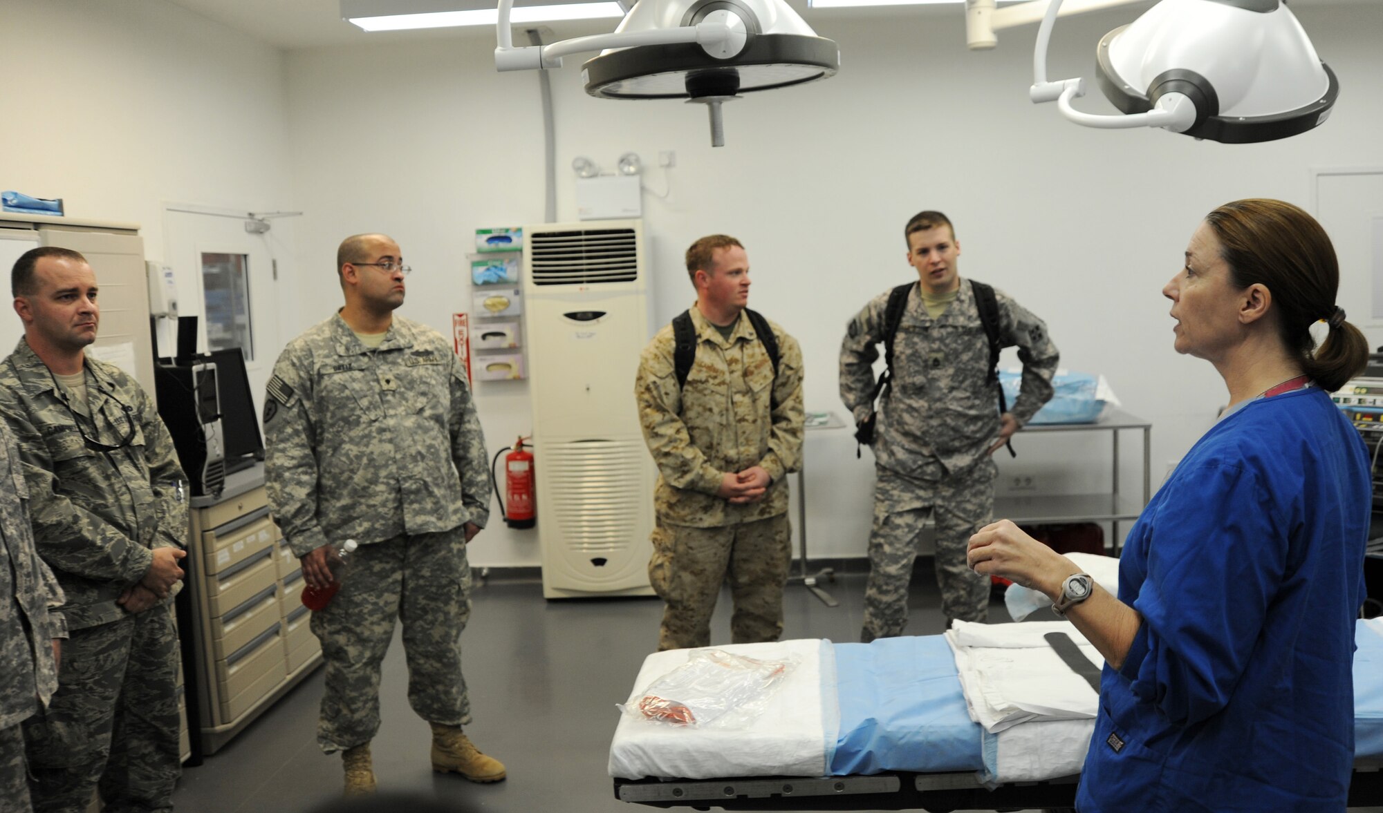 JOINT BASE BALAD, Iraq -- Lt. Col. Valorie Baggenstoss, right, 332nd Expeditionary Medical Operations Squadron operation room flight commander, briefs a group of formerly wounded servicemembers on the sequence of events that take place in the operating room Dec. 9, 2010. These wounded warriors visited here as a part of Operation Proper Exit which allows the wounded to return to Iraq and then leave the country on their own terms. (U.S. Air Force photo by Staff Sgt. Keyonna Fennell)