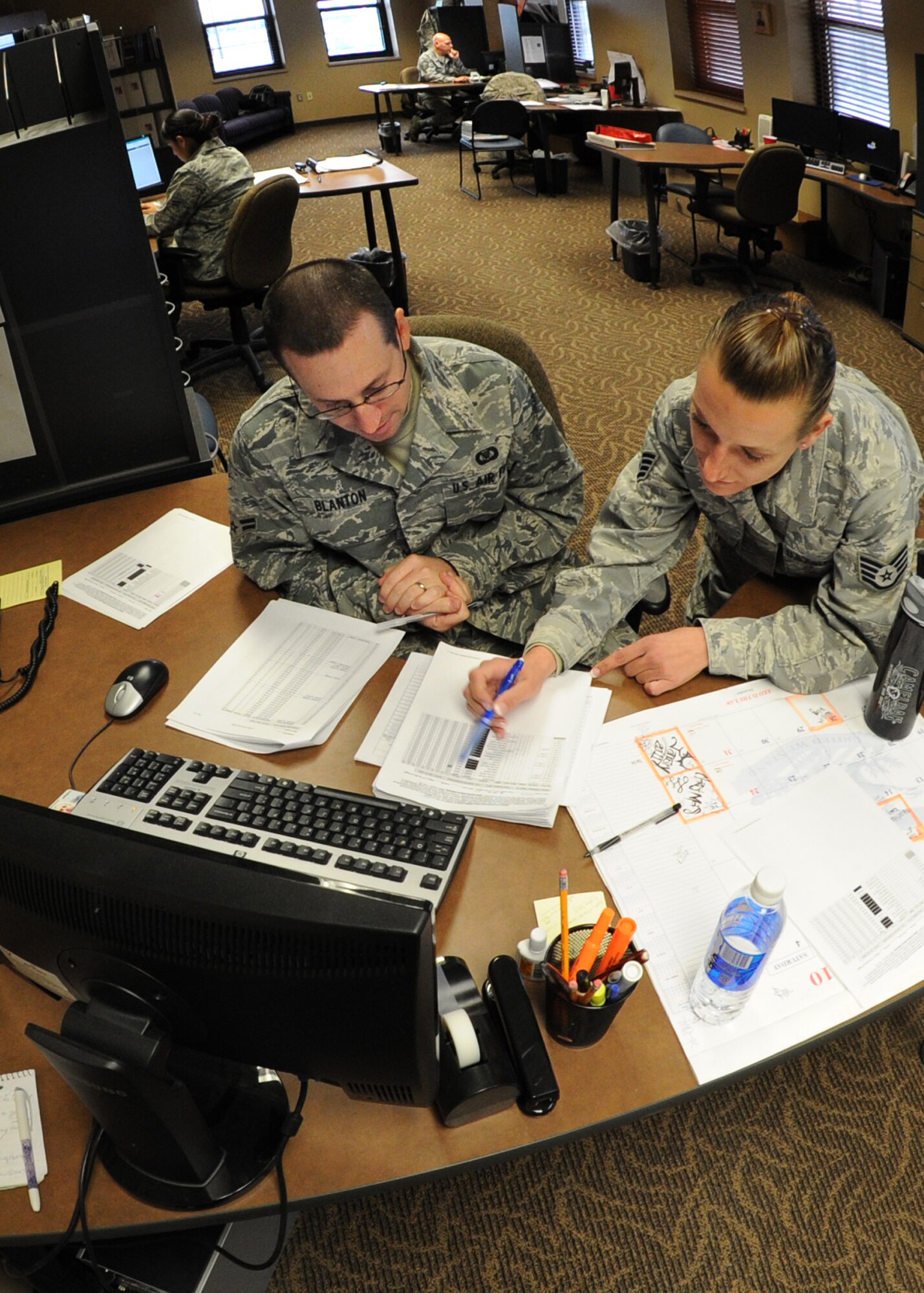 Staff Sgt. Michelle Rose, 22nd Operations Support Squadron Squadron Aviation Resource Management flight NCOIC, and Airman 1st Class Joe Blanton, 22nd OSS aviation resource management apprentice, sort aircrew training files and reports, inside the SARM section, Dec. 7, 2010, McConnell Air Force Base, Kan.  Members of the flight are responsible for ensuring all aircrew members meet training requirements before flying to prevent endangering personnel. (U.S. Air Force photo/Airman 1st Class Andrea Salazar)