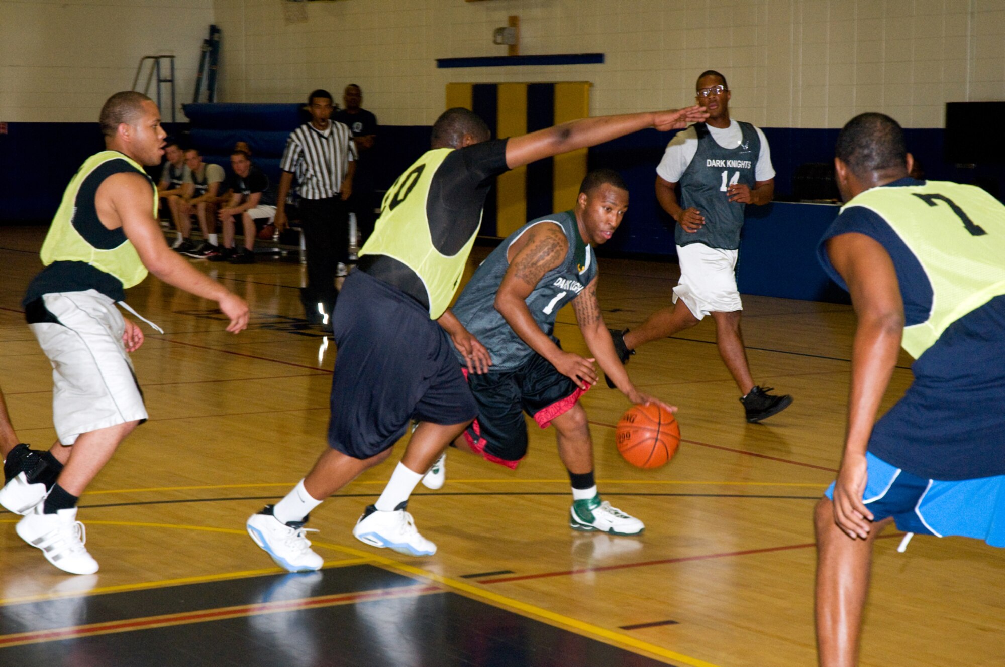 David Thatch, left, and Tranae Riley, right, block Kevin Watkins, 338th TRS-A, who’s backed up by Chastin Davis during a Eastern Conference matchup Dec. 2. The 81st LRS won, 51-43.  (U.S. Air Foce photo by Adam Bond)