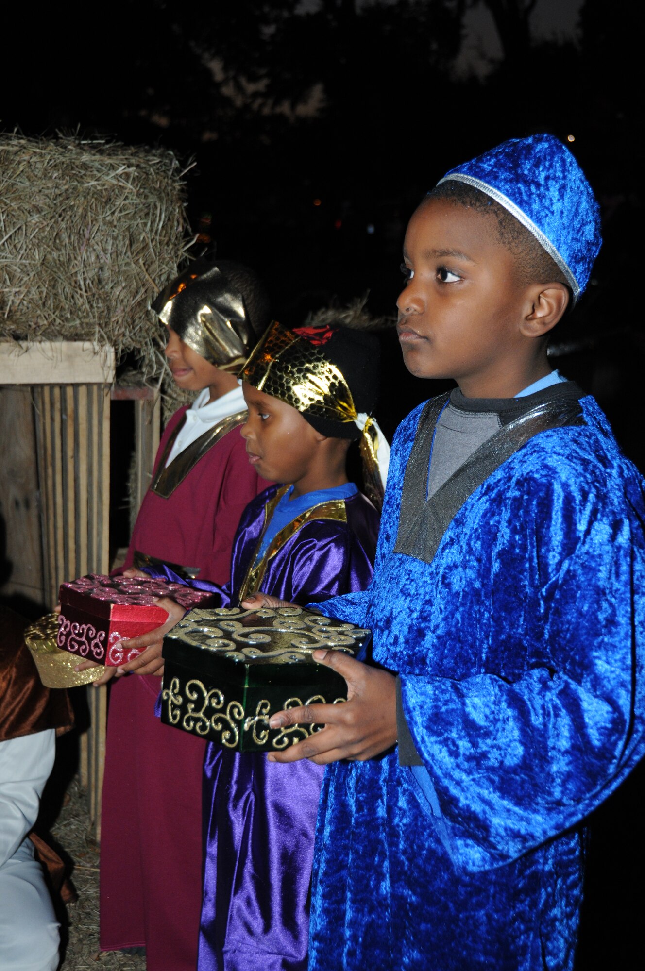 From left, C.J. McLean, B.J. Louis and Evan Housen portray the Three Wise Men in the chapel's nativity scene at Holiday in the Park, Dec. 1 at marina park.  C.J., 8, is the son of retirees Bernese and Charles McLean of Ocean Springs.  B.J., 6, is the son of Dedra and Brian Louis,  His dad works in the 81st Comptroller Squadron.  Evon, 9, is the son of Valerie and Evon Housen.  Mr. Housen is a civilian base engineer at the Coast Guard Aviation Training Center in Mobile.  (U.S. Air Force photo by Kemberly Groue)