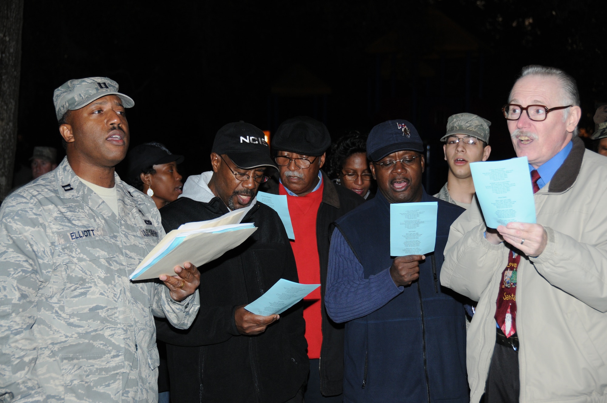 From left, Chaplain (Capt.) Ralph Elliott, Jr., LaShae Snider, Rhoan McIntyre, Laplace Jackson, Sheila Shepard, Greg Davis, Airman 1st Class Patrick Castro and Allan Micksch sing Christmas carols to get into the spirit. Airman Castro is assigned to the 81st Communications Squadron; Ms. Snider, Mr. Jackson, Mr. Davis and Mr. Micksch are retired Airmen;  Mr. McIntyre is a retired Sailor and Ms. Shepard is a retired Soldier.  (U.S. Air Force photo by Kemberly Groue)