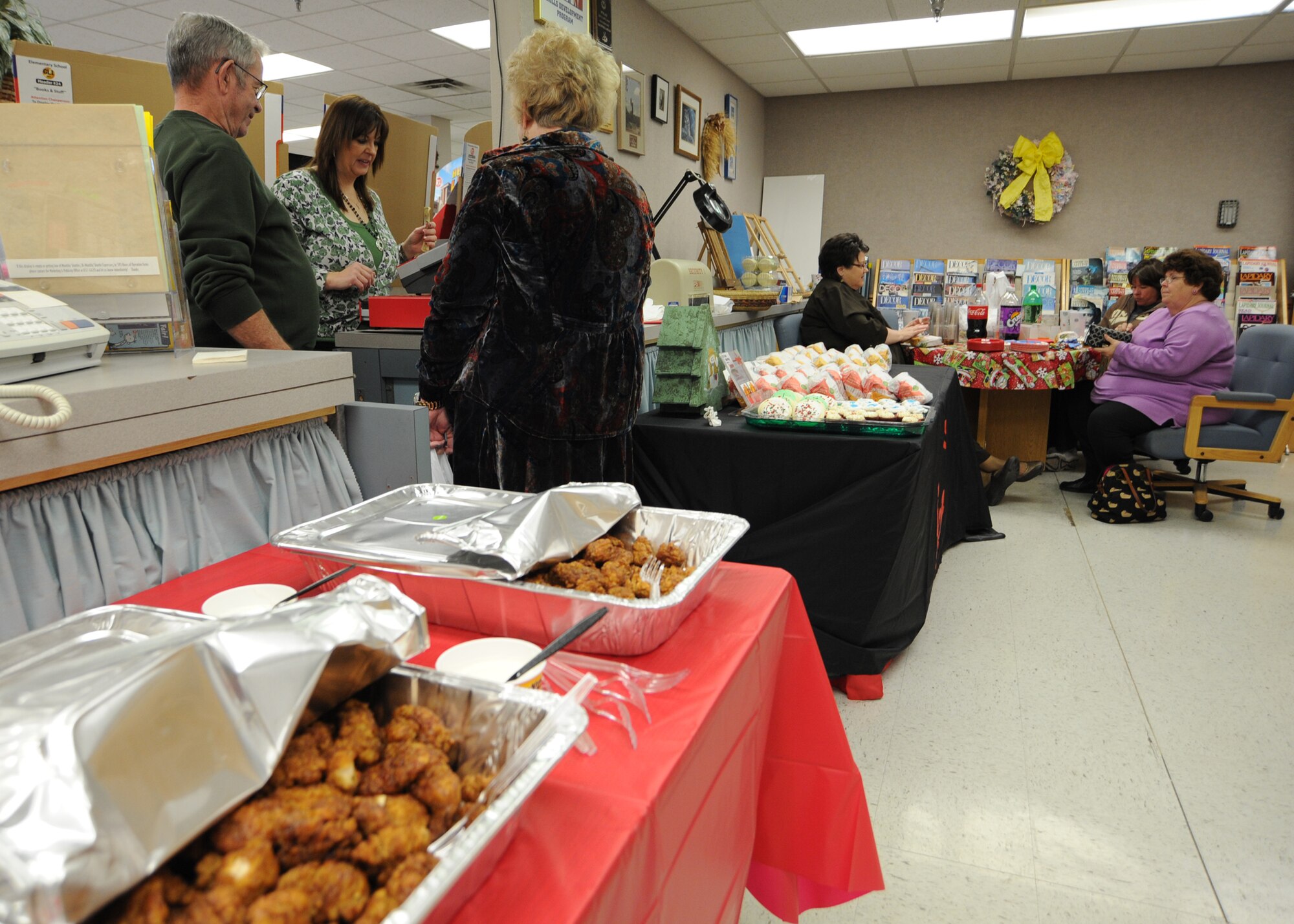 Team McConnell members gather and eat during the 15th annual Arts and Crafts open house Dec. 7, 2010, McConnell Air Force Base, Kan. The event shows appreciation to customers and showcases available classes and products at McConnell. Products and classes include frames, plaques, basket weaving, quilting and oil painting. Individuals can visit www.refuelmcconnell.com for additional information on arts and crafts products. (U.S. Air Force photo/Senior Airman Maria A. Ruiz)  