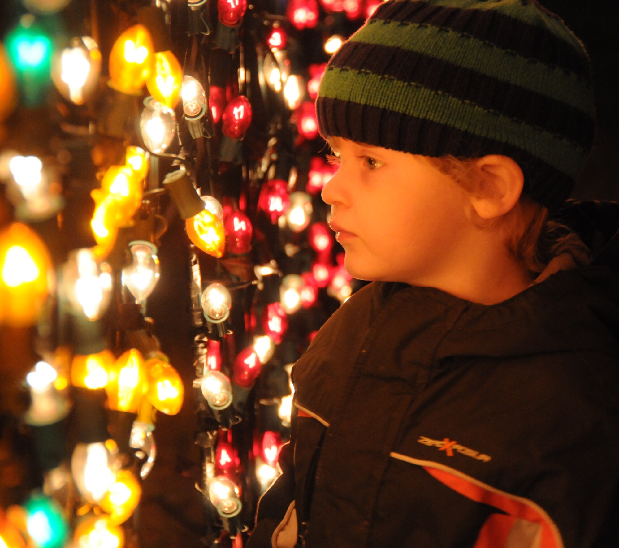 Peyton Parisi, 3, son of Master Sgt. Anthony Parisi, 81st Communications Squadron, has visions of colorful lights dancing in his head at Holiday in the Park, Dec. 1.  (U.S. Air Force photo by Kemberly Groue)