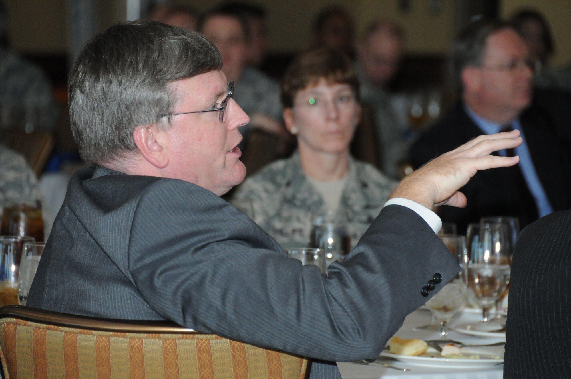 Brian Burns asks Alfred Rivera, guest speaker, a question during the Armed Forces Communications and Electronics Association luncheon Dec. 1 at the Bay Breeze Event Center. The event took place during ScopeWarrior, an annual strategic planning conference for senior Air Force communications leaders. Mr. Burns is deputy director for warfighting integration and chief information officer, office of the Secretary of the Air Force at the Pentagon.  (U.S. Air Force photo by Kemberly Groue)