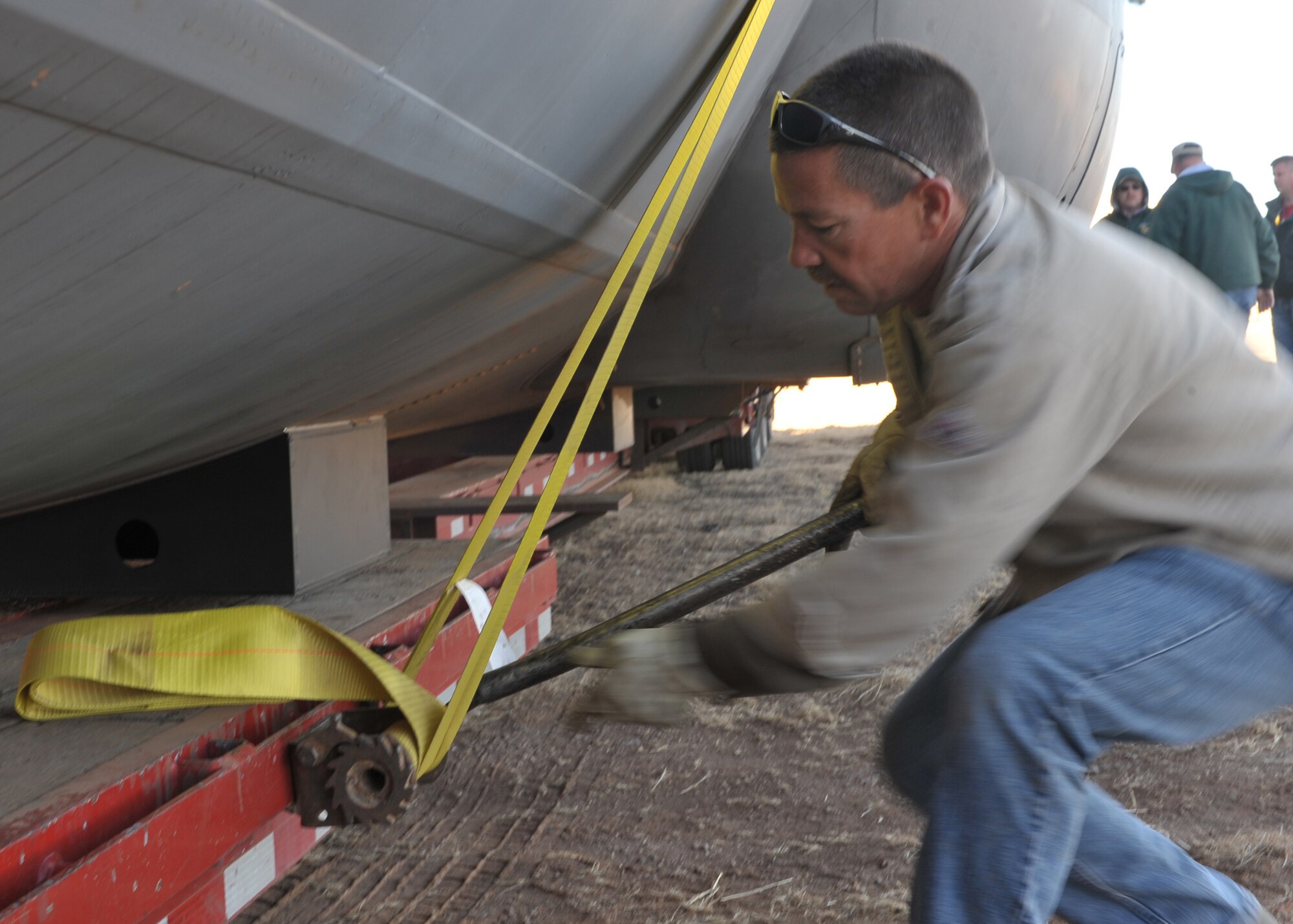 Sean Hofhine, a Southwest Industrial Rigging employee headquartered in Phoenix, Ariz., unfastens a fuselage trainer at Cannon Air Force Base, N.M., Dec. 8. The fuselage will allow Airmen the opportunity to train their loading and unloading capabilities using night vision equipment. (U.S. Air Force photo by Senior Airman James Bell)