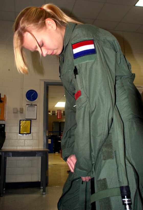 Marieke van Gaalen secures her G-suit Dec. 8 prior to a flight with the 88th Fighter Training Squadron. Ms. van Gaalen was awarded an incentive flight after she amassed the most recruiting points for the ROTC detachment at the University of North Texas. (U.S. Air Force photo/John Ingle)
