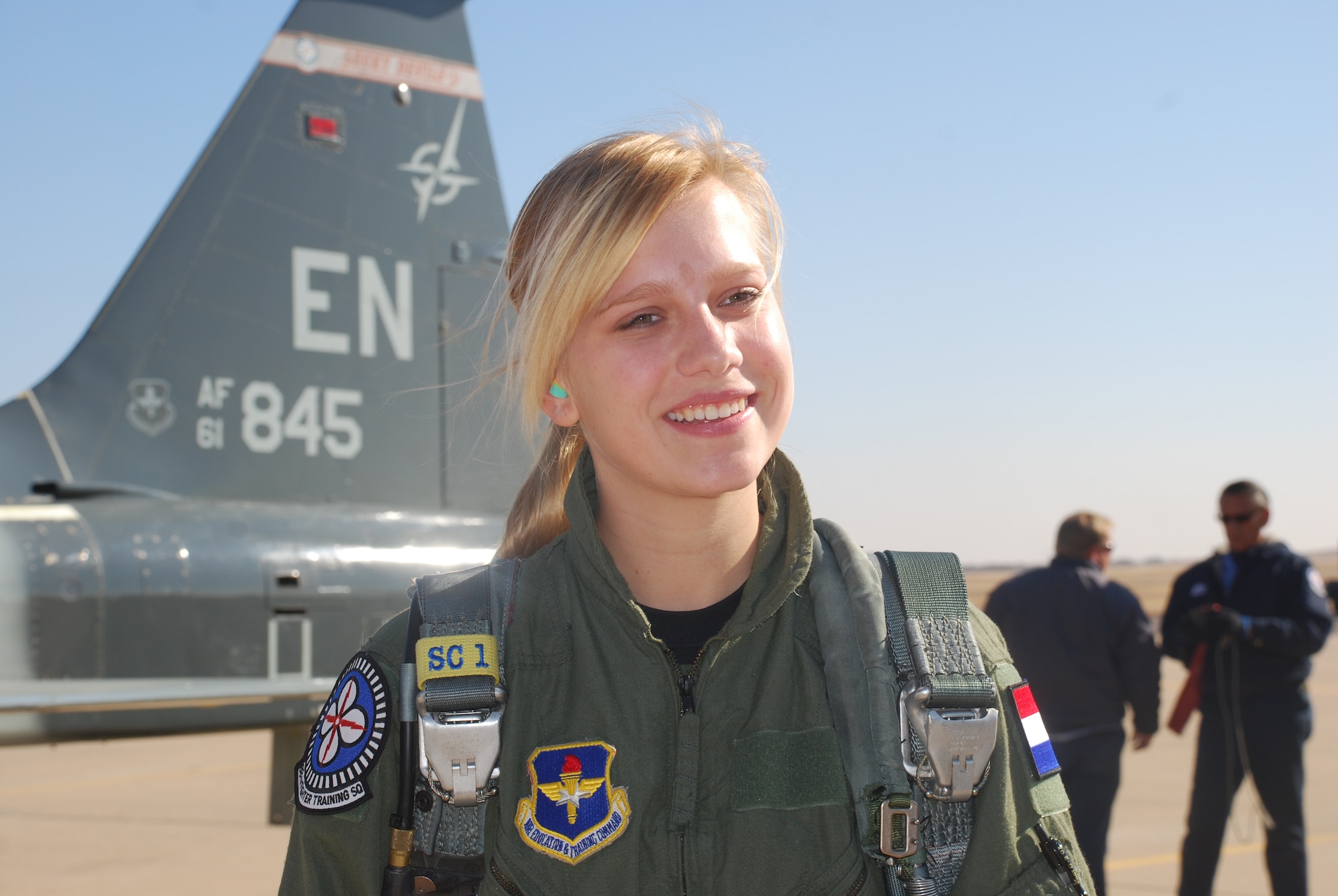 Marieke van Gaalen flashes a smile Dec. 8 prior to a flight with the 88th Fighter Training Squadron at Sheppard Air Force Base. Ms. van Gaalen, a student at Midwestern State University in Wichita Falls, Texas, and a cadet in the Air Force ROTC program at the University of North Texas in Denton, was in charge of recruiting students for the detachment at her home school. She led the detachment in points accumulated for recruitment efforts and was awarded a flight with the 88th FTS. She is the daughter or retired Royal Netherlands air force Lt. Col. William van Gaalen, who also served as the senior national representative at the Euro-NATO Joint Jet Pilot Training Program at Sheppard Air Force Base. (U.S. Air Force photo/John Ingle