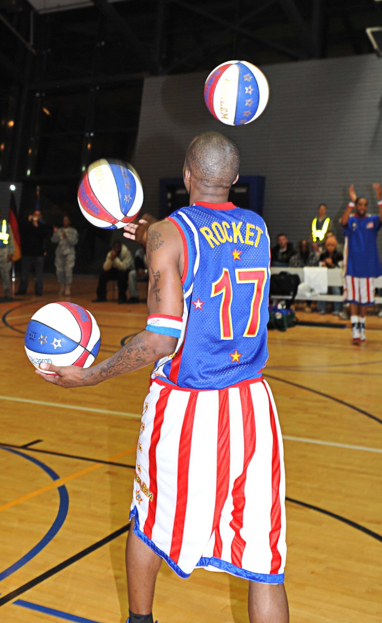Rocket Rivers, Harlem Globetrotter, performs basketball tricks for military members and their families, Ramstein Air Base, Germany, Dec. 8, 2010. The Globetrotters are celebrating their 85th year entertaining audiences around the world. (U.S. Air Force photo by Airman 1st Class Desiree Esposito)
